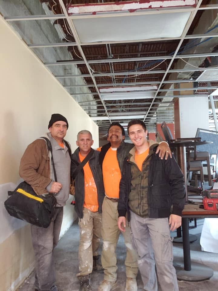 Ben with a construction crew at a renovation site